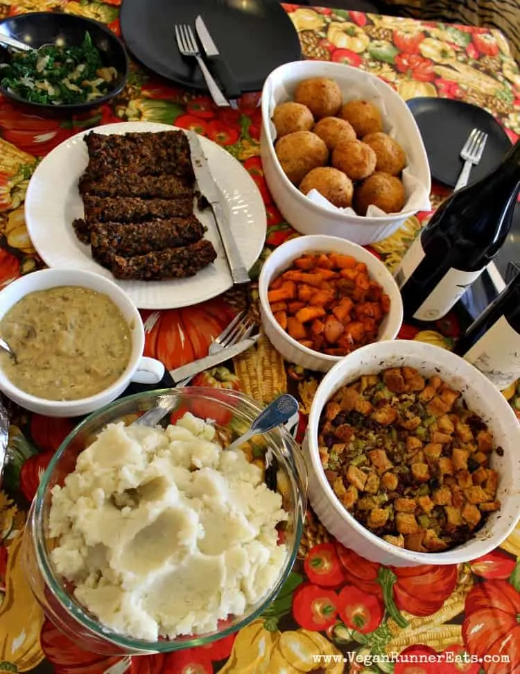 A vegan Thanksgiving table spread including sausage-stuffed Italian rice balls.